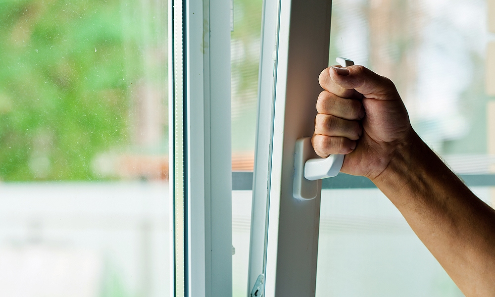 hand opening a window