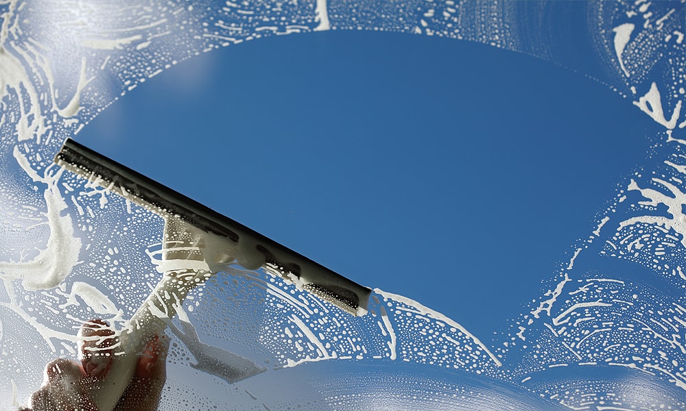 hand cleaning a window