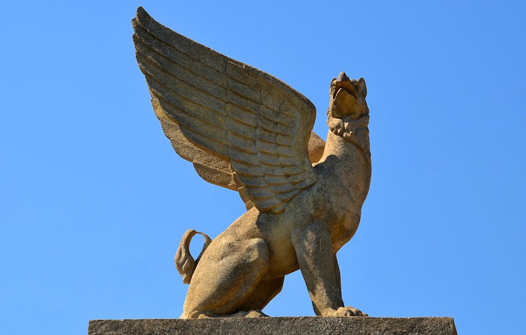 griffin statue with blue background