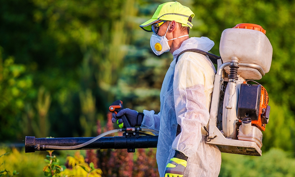 person spraying chemicals